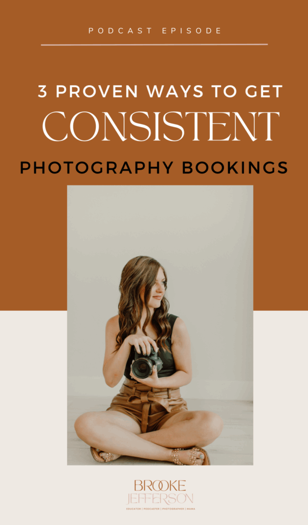 A smiling photographer holding a camera while meeting with a client, symbolizing consistent photography bookings and successful business growth.