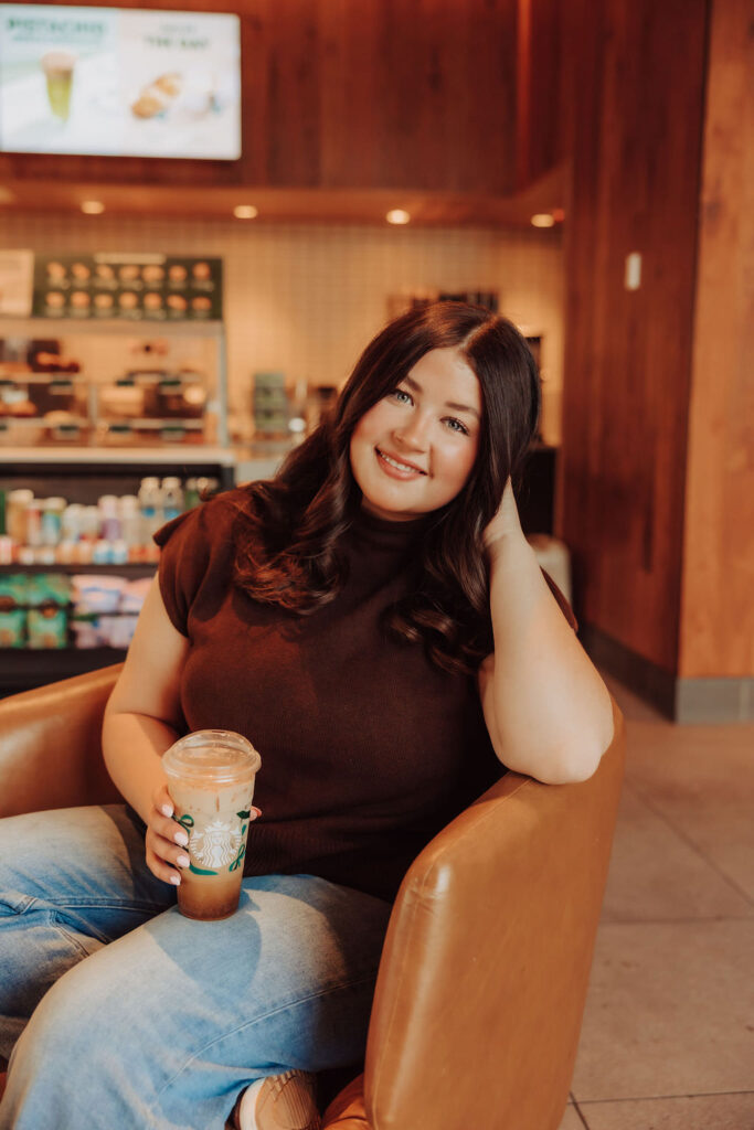 A Navajo High School senior holding a coffee at Starbucks